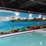 tropical bay with sailing ships image on swim school wall